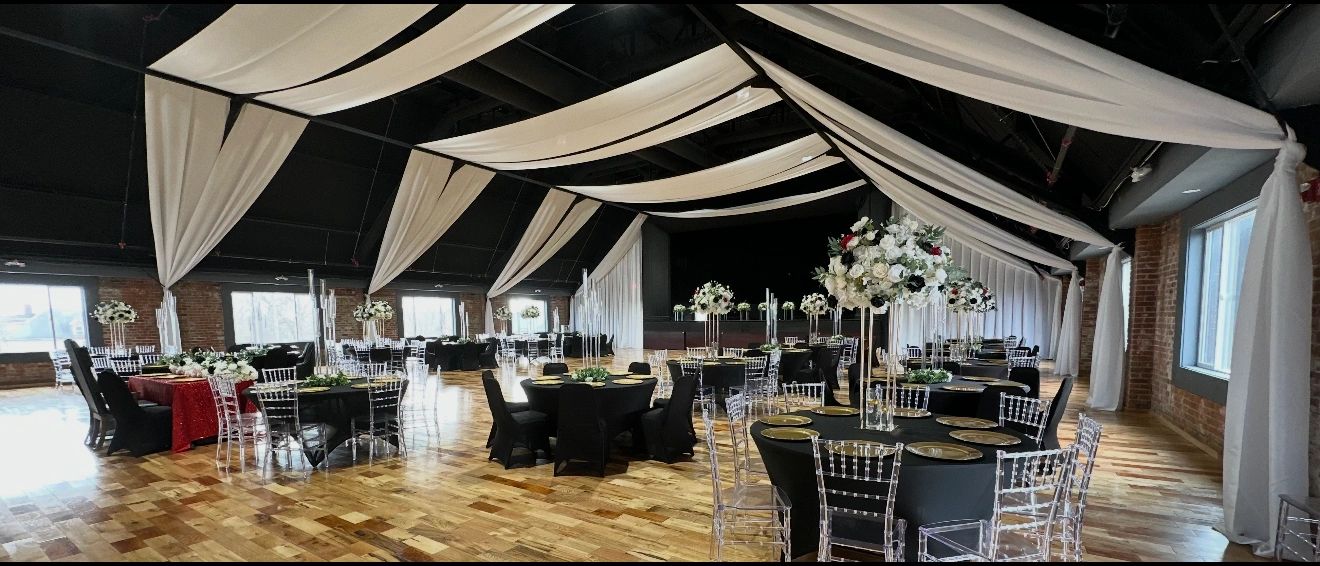 The Cadillac Showroom set with black linens under a white ceiling drape